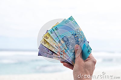 Samoan Tala currency - right hand holding bank notes from Western Samoa Stock Photo