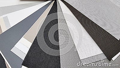 samples of roller blind fabrics in different textures and colors, close up view. roman curtain fabrics samples swatch. Stock Photo