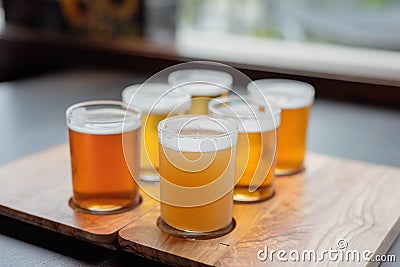 Sampling variety of beers from a beer flight Stock Photo