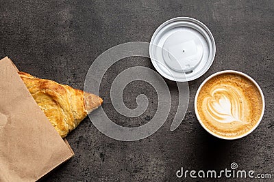 Samsa in paper envelope and cappuccino in paper cup on gray background top view Stock Photo