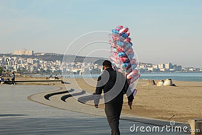 Samsun,Turkey - November 27, 2022 Man selling cotton candy on beach Editorial Stock Photo