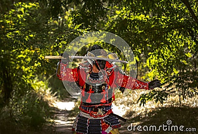 Samurai in ancient armor, with a sword ready to attack Stock Photo