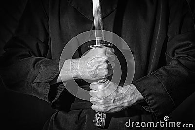 Samurai ready for battle holding a Japanese katana swordr, in black and white Stock Photo