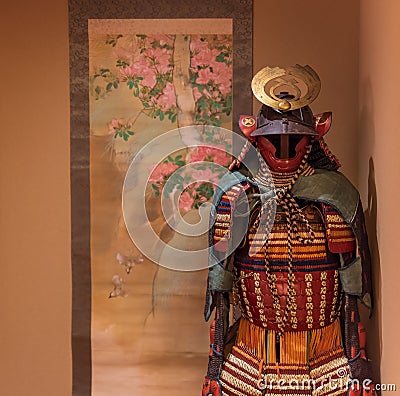 Samurai suit of armor standing next to Japanese painting Editorial Stock Photo