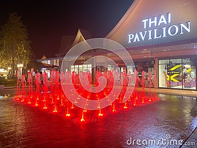 Samut Prakan, Thailand - January 1, 2020 : Thai Pavilion and light fountain at night in the newly open premium outlet mall locates Editorial Stock Photo