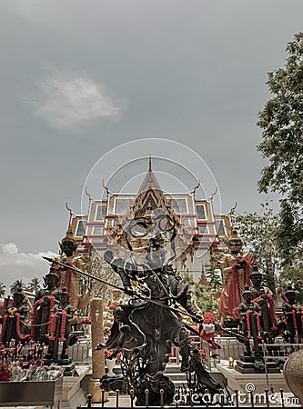 Black Nezha guardian deity sculpture and Thao wessuwan sculptures Stock Photo