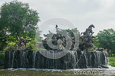 Samutprakarn / Thailand - Ausust 12 2019: handicraft sculpture of ancient god with strong horses decorated on waterfall in Ancient Editorial Stock Photo