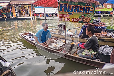 Unacquainted Thai people Selling local Food on the boat in Amphawa Floating market in holiday time Editorial Stock Photo