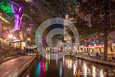 The San Antonio River Walk by night with illuminated trees and restaurants. City park and pedestrian street in San Antonio, Texas Editorial Stock Photo