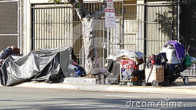 SAN DIEGO, CALIFORNIA USA - 4 JAN 2020: Stuff of homeless street people on walkway, truck on roadside. Begging problem in downtown Editorial Stock Photo