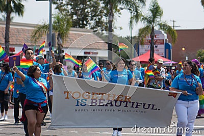 SAN DIEGO - JULY 15: Unidentified men and women march for Wells Fargo in the LGBT Pride Parade. Editorial Stock Photo