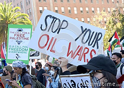 Participants holding signs marching and protesting APEC meeting in San Francisco, CA Editorial Stock Photo