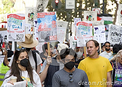 Participants holding signs marching and protesting APEC meeting in San Francisco, CA Editorial Stock Photo