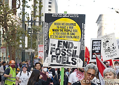 Participants holding signs marching and protesting APEC meeting in San Francisco, CA Editorial Stock Photo