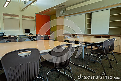 Empty grade school classroom with Apple Mac computer in back Editorial Stock Photo
