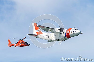 Coast Guard helicopter and plane flying in air show Editorial Stock Photo