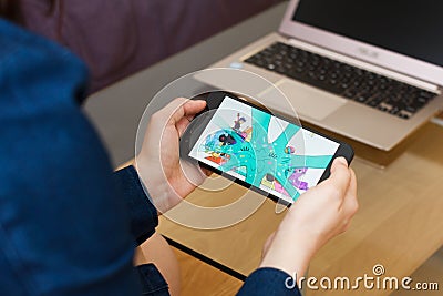 SAN FRANCISCO, US - 22 April 2019: Close up to female hands holding smartphone using YouTube Kids application, San Francisco, Editorial Stock Photo