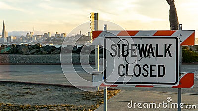 Sidewalk closed sign with view of San Francisco port at sunset Editorial Stock Photo