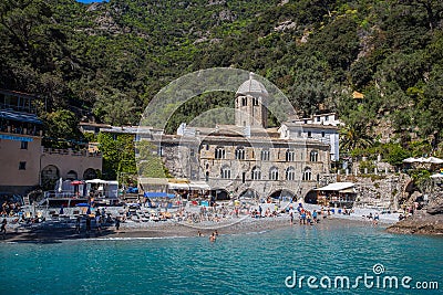 San Fruttuoso di Camogli, Ligurian coast, Genoa province, with its ancient Abbaey, the beach and tourists. Italy Editorial Stock Photo