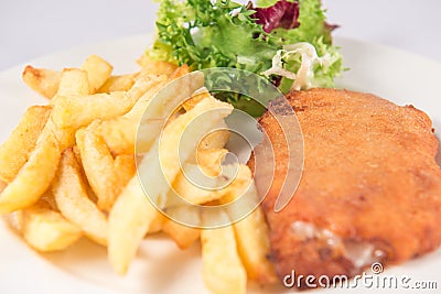 San Jacobo steak filled with cheese with French fries and endive. Stock Photo