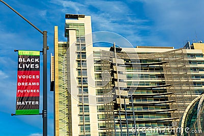 San Jose City Hall exterior under blue sky. Black Lives Matter banner with phrase Voices. Dreams. Futures and display the colors Editorial Stock Photo