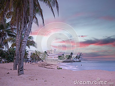 San Juan, Puerto Rico. January 2021. People is resting on San Juan`s Ocean Park Beach after a day`s work just before sunset Editorial Stock Photo