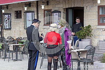 SAN MARINO - APRIL 09, 2019 - A policeman issues a fine to street actors Editorial Stock Photo