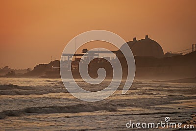 San Onofre nuclear power plant at sunset in misty fog with beach in foreground Stock Photo