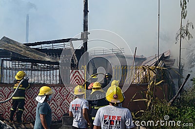 Firemen and volunteers working extinguishing fire on a subdivision house Editorial Stock Photo