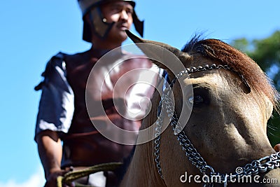 Interpretation of horse riding Roman soldier, community celebrates Good Friday with the Catholic traditional procession Editorial Stock Photo