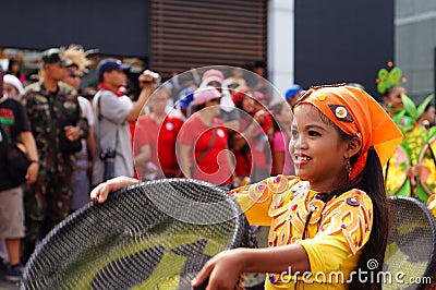 Girl carnival dancer in ethnic costumes dances in delight along the road Editorial Stock Photo