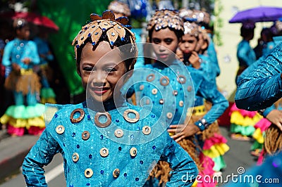 Girl carnival dancer in ethnic costumes dances in delight along the road Editorial Stock Photo