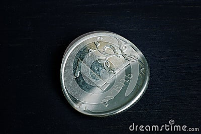 Sanctions and inflation concept. Bent Russian ruble on dark background Stock Photo