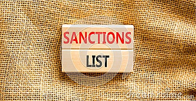 Sanctions list symbol. Wooden blocks with concept words Sanctions list on beautiful canvas background. Business political Stock Photo