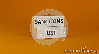 Sanctions list symbol. Wooden blocks with concept words Sanctions list on beautiful orange background. Business political Stock Photo