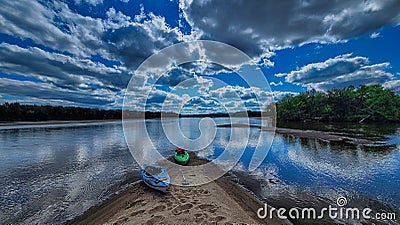 Kayaks along a sandbar near Spring Green on the Wisconsin river with clouds reflecting in the water Stock Photo