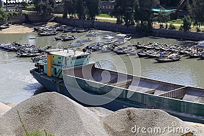 Sand barge unloading at the dock Editorial Stock Photo