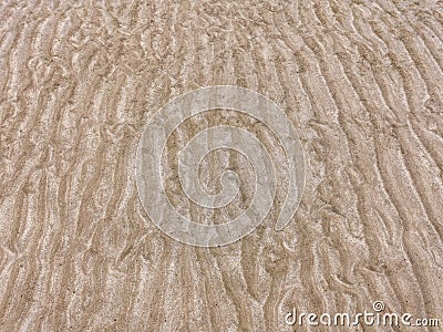 Sand on the beach for background. Brown beach sand texture. Close-up sand pattern. Top view wavy sand background for summer design Stock Photo