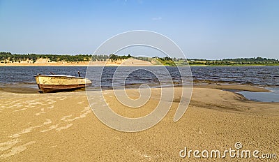 Sand beach. Boat on the shore. Stock Photo