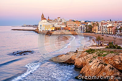 Sand beach and historical Old Town in mediterranean resort Sitges, Spain Stock Photo
