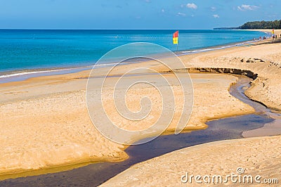 Sand beach pollution. Black water in creek on sand Stock Photo