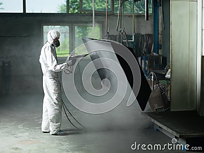 Sand blasting a metal Stock Photo