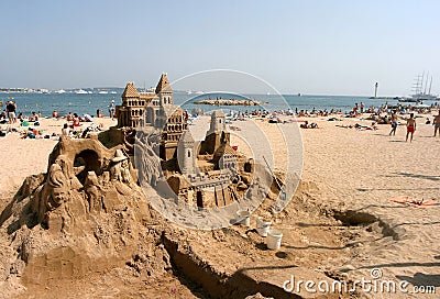 Sand castle and sunbathing people Editorial Stock Photo