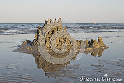 Sand castle on the water made from drops of a liquid mixture of water and sand Stock Photo