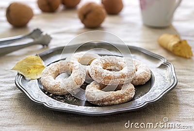 Sand dough biscuits, coffee and walnuts on a linen tablecloth. Rustic style. Stock Photo