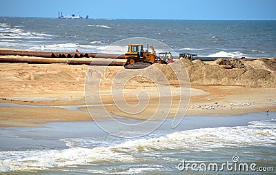 Sand dredger on beach Stock Photo