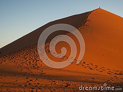 Sand dune ridge to summit with footprint in vast desert Stock Photo