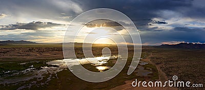 Sand dunes Bayan Gobi and lake at sunset Stock Photo