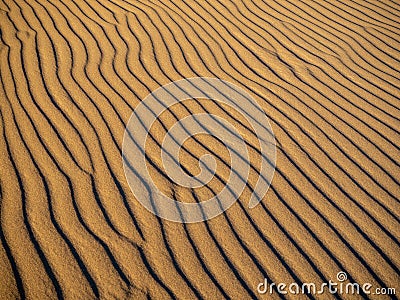 Sand dunes in Morocco, desert landscape, sand texture, tourist camp for night stay, panorama view of sunset over Sahara Stock Photo