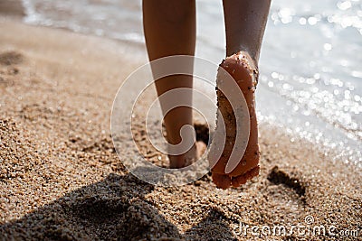 Sand on feet sole of woman Stock Photo